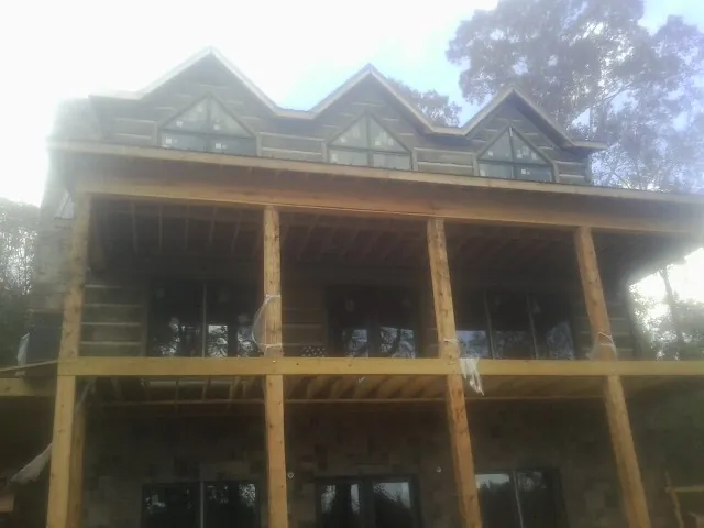Dormers and porch framing on a large log home under construction in Wilmington
